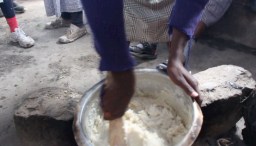 Njoguini PA-MOJA club student cooks ugali.